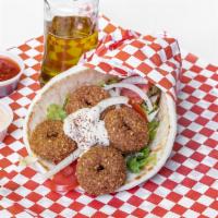 Falafel Gyro · 5 pieces falafel rolled with pita bread pita, lettuce,  tomatoes,pickles, onions, hummus and...