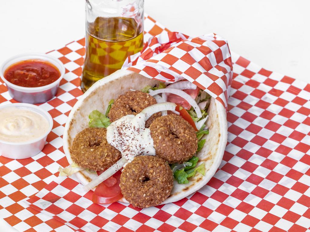 Falafel Gyro · 5 pieces falafel rolled with pita bread pita, lettuce,  tomatoes,pickles, onions, hummus and tzatziki.