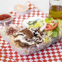 Lamb Gyro Combo · Well seasoned lamb gyro cooked on the top griddle, on a bed of basmati rice topped with hous...