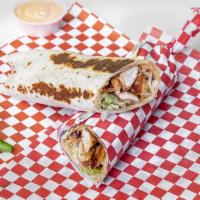 Chicken Saj · Chicken shawarma, hummus, lettuce, tomatoes, pickles, fresh onions, topped with the house ga...