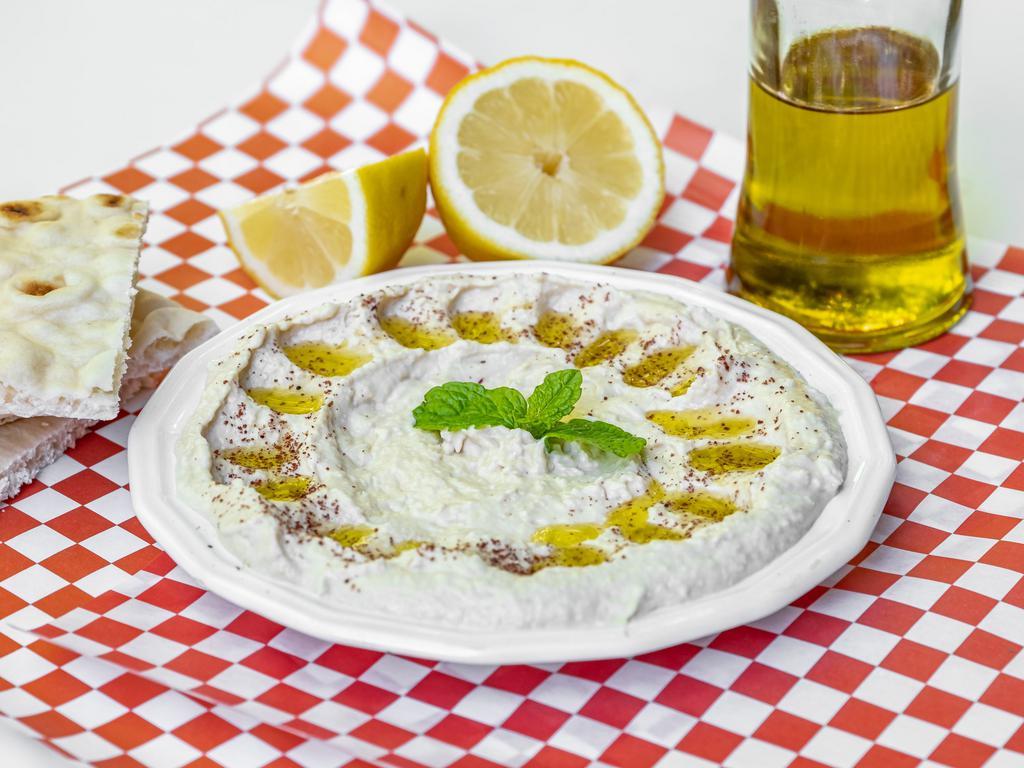 Hummus Plate · Pureed chickpeas with tahini sauce lemon juice serve with pita bread and extra virgin olive oil.