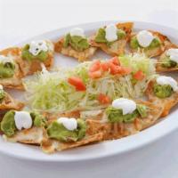 Nachos with Melted Muenster Cheese · Fresh homemade tortilla chips topped with melted Munster cheese, fresh homemade guacamole an...