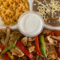 Chicken Fajitas Tres Colores Plate · Marinated strips of chicken breast grilled with tricolo red, yellow and green peppers with S...