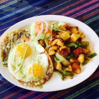 Huevos Rancheros · Fried eggs, tortilla, sauce, beans, cheese, creame and home fries.