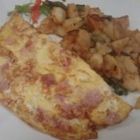 Omelet de Jamon y Queso · Eggs, ham, cheese, tomatoes and onions.