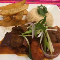 Lomo Saltado · Sauteed strip of beef with onions, tomatoes and golden fries served with rice.