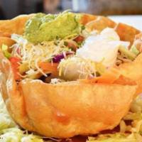 Taco Salad · Lettuce, tomatoes, crema, cheese, guacamole, deep fried flour tortilla with a choice of chic...