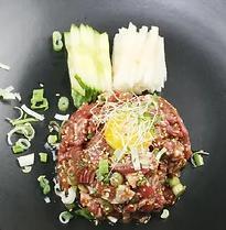 Yuk Hwe · Korean styled a steak tartare with Asian pear, cucumber, egg yolk, pine nut, and sesame seeds.