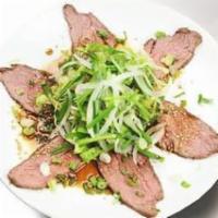 Roast Beef Salad · Sliced roast beef and chive salad with house ponzu sauce. Scallion and sesame seeds on top.