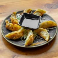 Fried Gyoza · 8 pieces. Japanese dumplings filled with chicken and vegetables, served either fried.