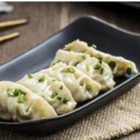 Steamed Gyoza · 8 pieces. Japanese dumplings filled with chicken and vegetables, served either steamed.