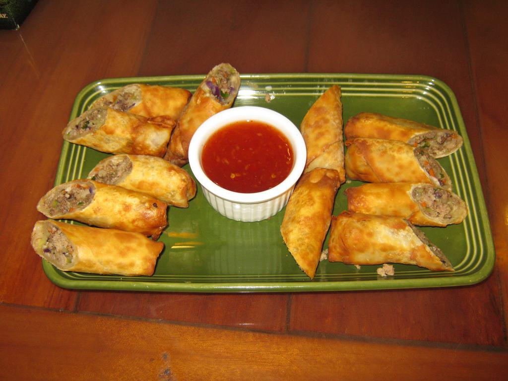Lumpia · 6 wonton wrappers stuffed with beef, pork, cabbage, green onions, and carrot deep fried and served with sweet chilli sauce.