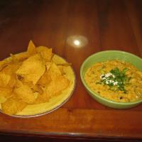 Nachos · Fresh corn chips covered with our house cheese sauce, pico de gallo, green onions, olives an...