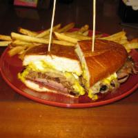 The Cuban Sandwich · Pulled pork, smoked ham, Swiss cheese, yellow mustard and grape jelly pressed on a bollilo b...