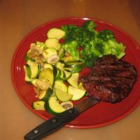 Steaks · Flame broiled to perfection served with a loaded baked potato and veggies and a dinner salad.