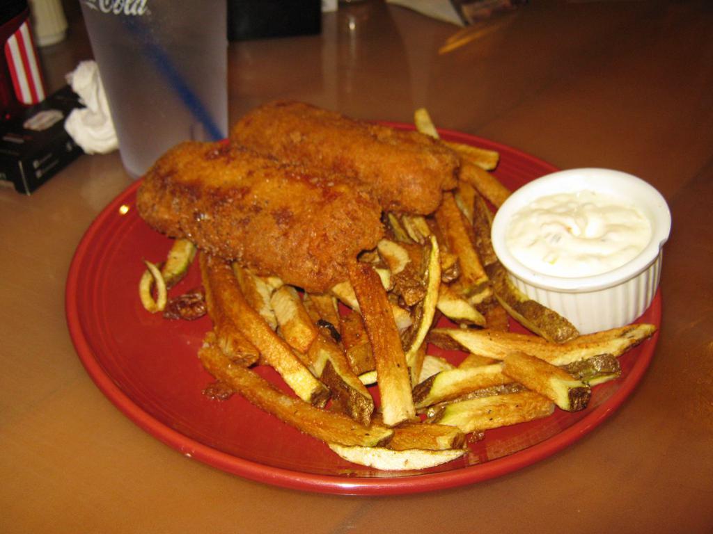 Fish and Chips · Battered cod served with fries and tarter sauce.