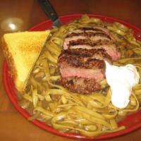 Beef Stroganoff · An 8 oz. iron steak cooked to order on top of a pile of fettuccini noodles with sauteed mush...
