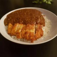 Chicken Cutlet Curry · With curry sauce and rice.