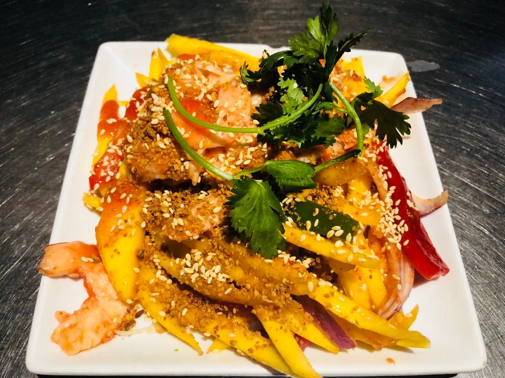 A9. Pasang Mango Shrimp · A red-green pepper salad served with fresh mango and grilled shrimp spread over sweet sour spicy sauce sprinkled with peanut sesame seeds.