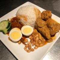 R6. Nasi Lemak · Coconut flavored rice with belacan anchovy, chicken, hard boiled egg and peanuts.