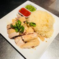 R9. Hainanese Chicken on Rice · Steam rice in chicken broth. Chicken with or without bone.Dipping sauce of chili and freshly...