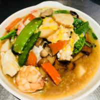 U8. Egg and Seafood Fried Flat Rice Noodle · Fried flat noodles with prawns, fishcake, squid, crab meat and assorted vegetables over shri...