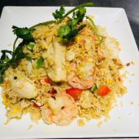 F8. Coconut Seafood Fried Rice · Fried coconut rice in turmeric powder with seafood and fish cakes,