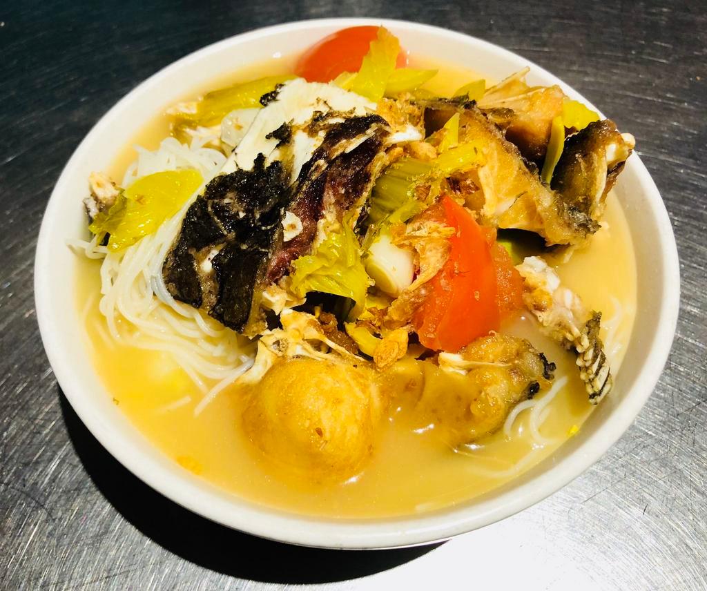 Crispy Fish Head with Preserved Vegetable Noodle Soup · Crispy fish head served with tomato, pickled cabbage and ginger in chicken broth soup.