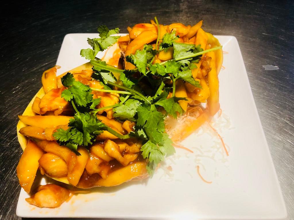 C9. Mango Chicken · Sauteed chicken with shredded mango, green and red pepper in  spicy sweet and sour sauce, served in mango shell.