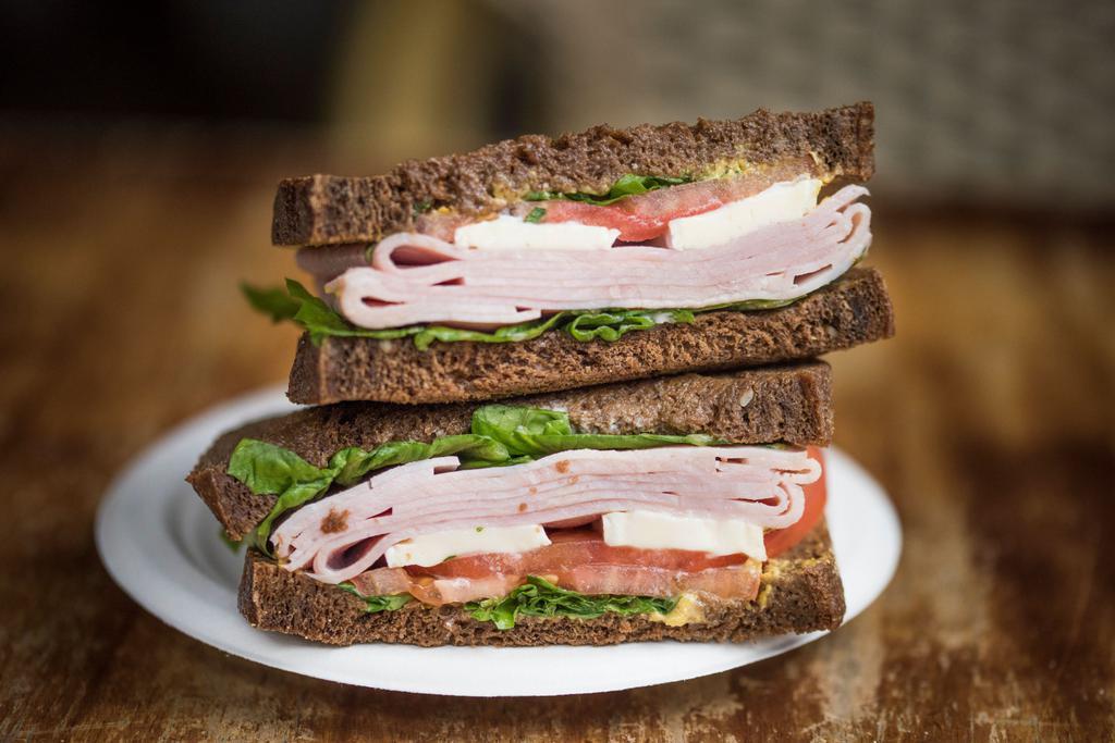 Ham and Brie Sandwich · French ham, brie cheese, tomatoes, watercress, lemon mayo and Dijon mustard on pumpernickel bread