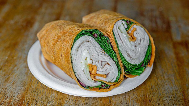 Turkey Wrap · Smoked turkey, brie cheese, Granny Smith apple, baby lettuce and honey mustard on sun-dried tomato or spinach tortilla