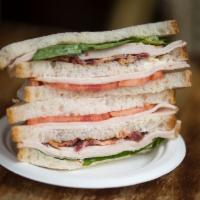 Turkey Club Sandwich · With bacon, tomatoes, romaine lettuce and mayo on white pullman