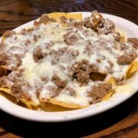 Nachos con Carne · Nachos with Cheese and Ground Beef and Cheese Sauce.