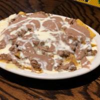 Nachos Beef & Bean · Nachos with cheese, ground beef and refried beans and cheese sauce.