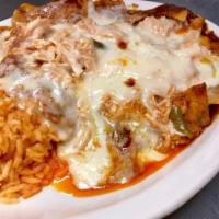 Chilaquiles · Tortilla chips covered with Ranchero sauce and smothered and melted cheese and chicken. Serv...