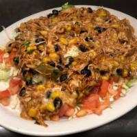 Southwest Salad · Shredded chicken with black beans and corn over a bed of lettuce tomatoes and cheese.