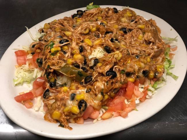 Southwest Salad · Shredded chicken with black beans and corn over a bed of lettuce tomatoes and cheese.