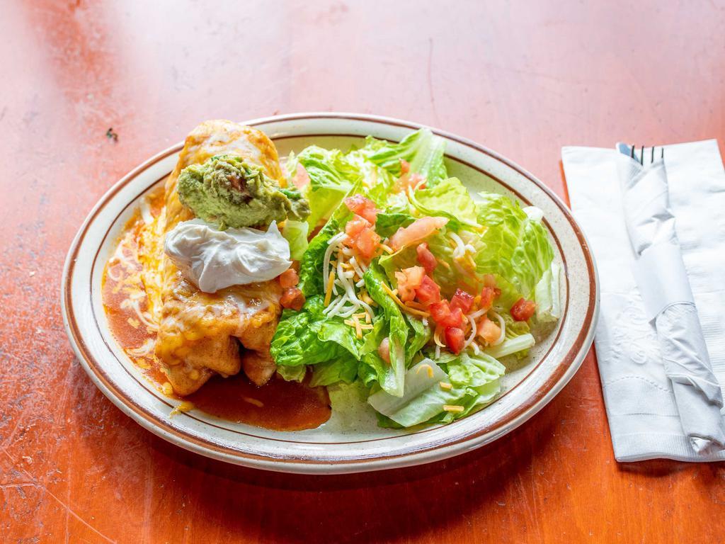 Deluxe Chimichanga · Choice of ground beef, chicken or picadillo. Served enchilada style, with salad, rice and beans.
