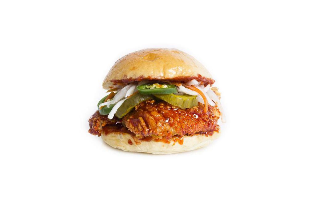 Spicy Chicken Sandwich · Crispy tender, pickle, jalapeno, green leaf, tomato, red onion with kuku spicy sweet & spicy sauce on a brioche bun