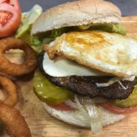 Texas Burger · Topped with a fried egg, lettuce, tomatoes, onions, pickles, fresh mozzarella cheese and may...