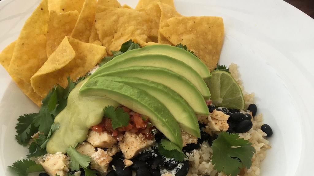 Super Bowl *GF · Spanish rice, organic black beans, all-natural chicken breast, house salsa, Cotija cheese, cilantro, sliced avocado, and house avocado dressing. Served with gluten-free tortilla chips, lime wedge.