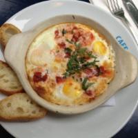 Organic Baked Eggs with Salmon · Capers, potatoes and cream.