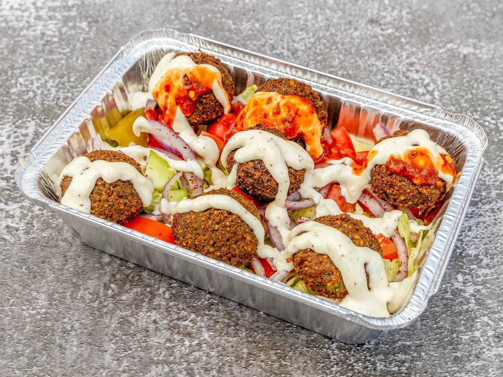 13. Falafel Salad · Falafel (7 pieces), lettuce, cucumber, tomatoes, red onion, pickle, white sauce, and hot sauce.