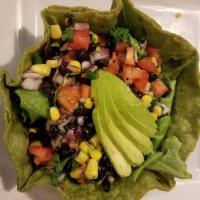 D. Martha Salad · Tortilla bowl containing a mix of black beans, cilantro, pico de gallo, corn, and baby spina...