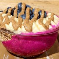 The Nutty Bowl · Pitaya blend with almond butter topped with banana, blueberry almond butter gluten free gran...