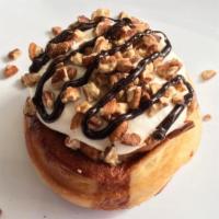 Turtle Roll · caramel frosting topped with chopped pecans and chocolate sauce