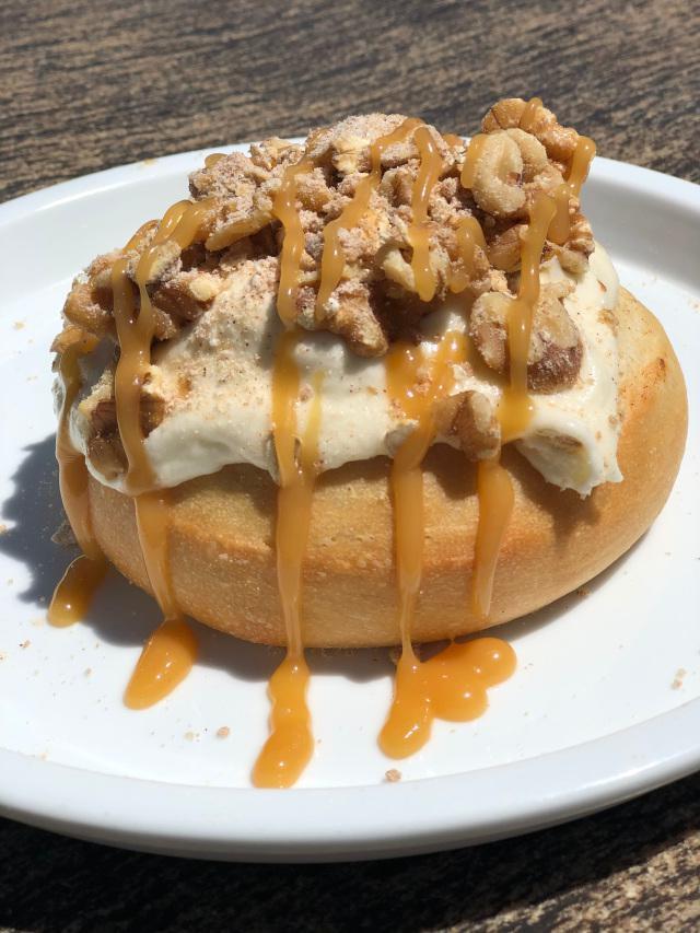 Sun City Roll · amaretto frosting topped with homemade pie crumbles, walnuts and caramel sauce