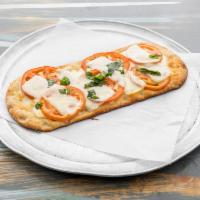 Traditional Margherita Flatbread · San Marzano tomato sauce, fior di latte mozzarella, extra virgin olive oil and basil.