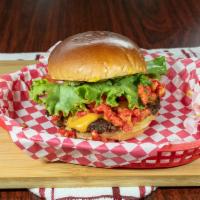Flash Point Burger · Hot cheetos piled on a patty with nacho cheese sauce, mustard, pickles, tomato and lettuce. 