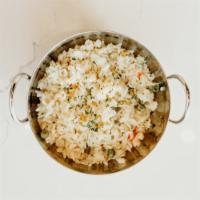 Rice Pilaf · Yellow rice pilaf with carrots, peas, corn, onions, and a hint of garlic.  You will not find...